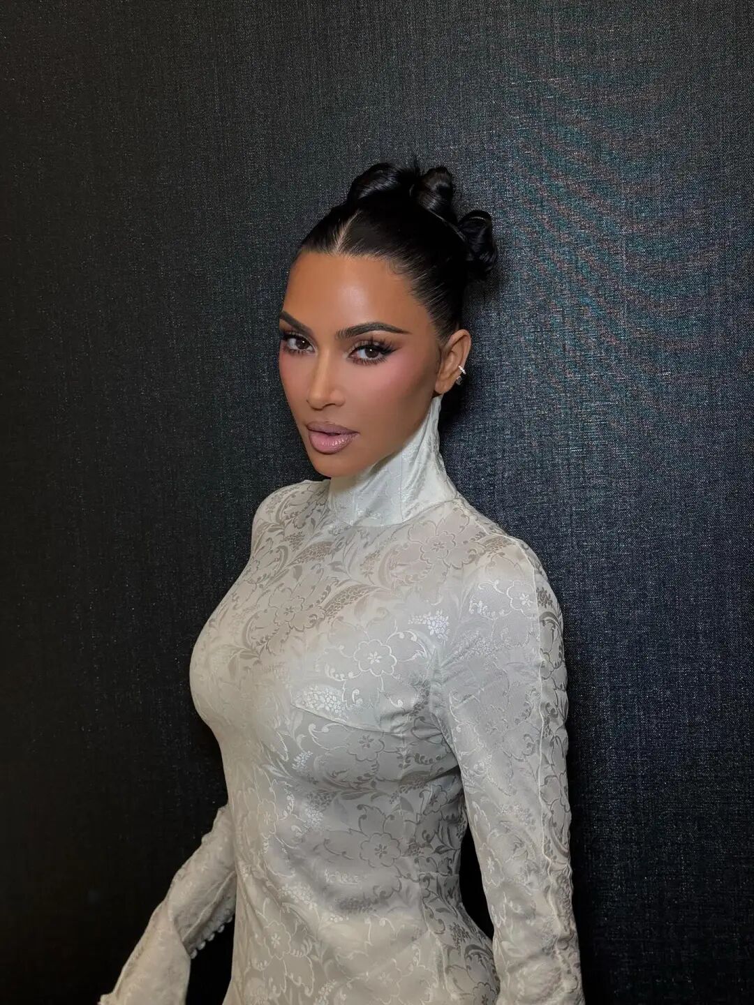 Photo by Kim Kardashian on October 29, 2025. May be an image of one or more people, makeup, eyeliner, dress and text.